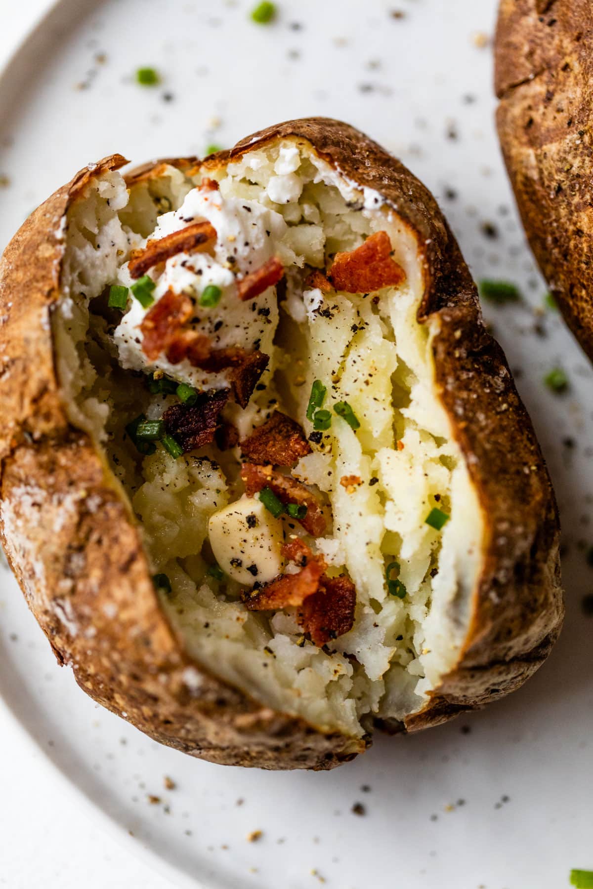 A crispy air fryer baked potato with bacon