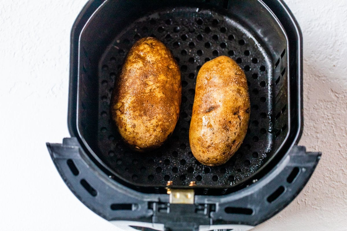 Two potatoes in an air fryer