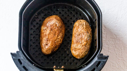 Two potatoes in an air fryer